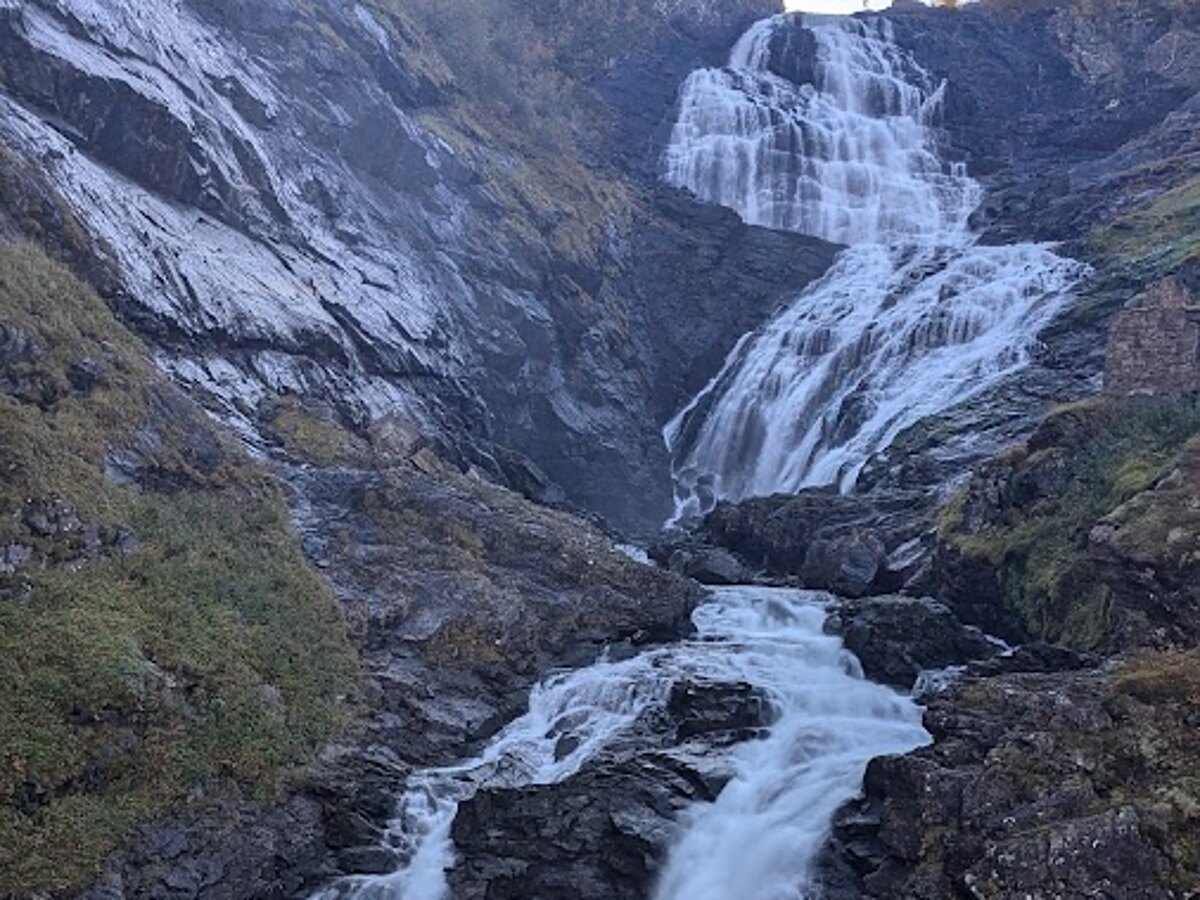 Kjosfossen waterfall plunging down the steep mountain canyon wall in Flåm